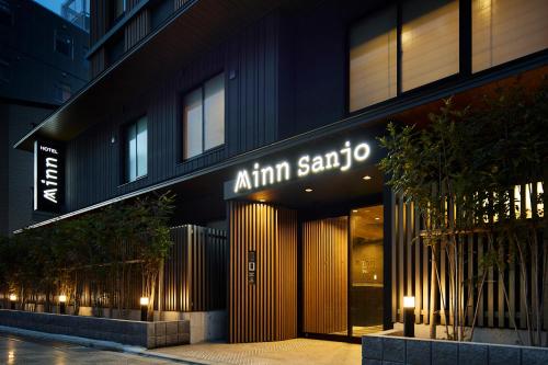 a building with a sign on the front of it at Minn Gion Sanjo in Kyoto
