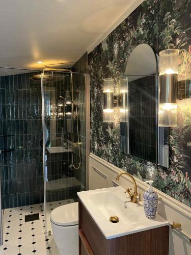 a bathroom with a shower and a sink and a toilet at Stryn - house by the river in Stryn