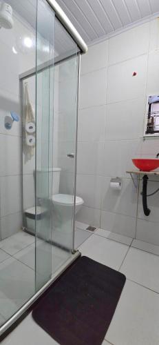 a bathroom with a glass shower and a toilet at Pousada Mar Dos Anjos in Arraial do Cabo