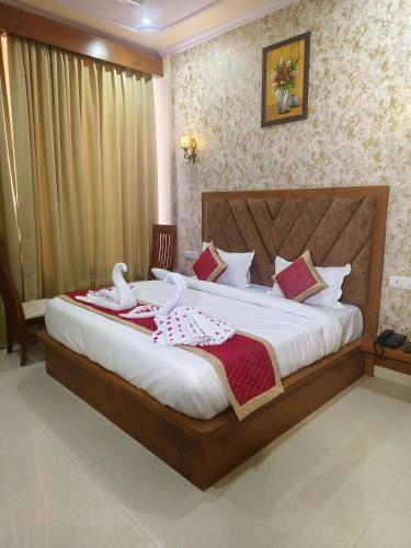 a bedroom with a large bed with towels on it at Hotel Narayan Vilas , Jaipur in Jaipur