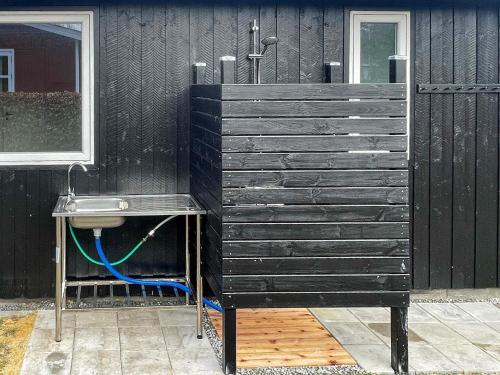 a bathroom with a sink next to a black wall at 6 person holiday home in Tarm-By Traum in Tarm