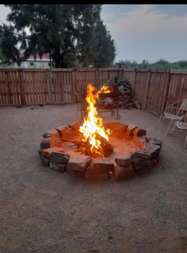 a fire pit in the middle of a yard at Rooidam Farm Accomodation in Modderrivier