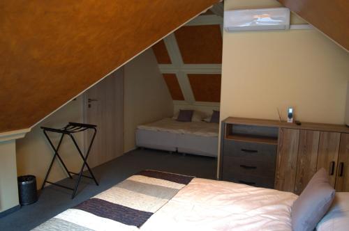 a bedroom with a bed and a desk in a attic at Villa Quality Wellness in Dozmat