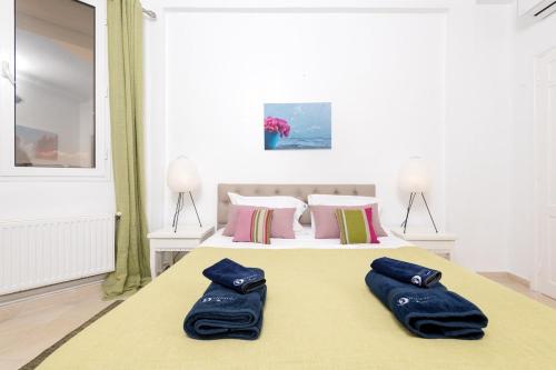 a bedroom with a bed with two blue towels on it at L'Horizon in Gammarth