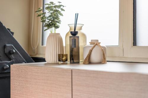 a counter with vases and other items on it at Cosy Mezzanine Apartment Leeds City Centre in Leeds