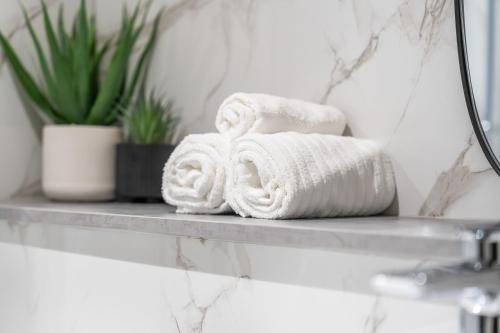 two towels on a shelf in a bathroom at Cosy Mezzanine Apartment Leeds City Centre in Leeds