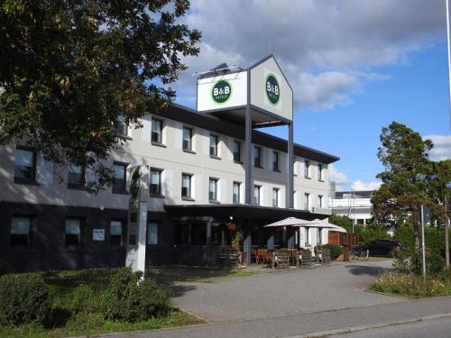 a hotel with a sign in front of it at B&B HOTEL Regensburg-Ost in Regensburg