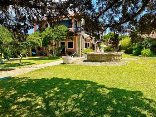 a house with a large shadow on the grass at Genari Beach Apartments Sea View Apartment for Couples or Small Families in Korakokhórion