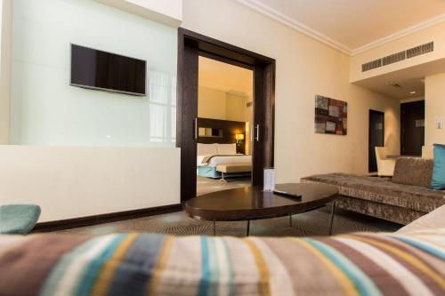 a living room with a couch and a table in a hotel room at Holiday Inn Abu Dhabi by IHG in Abu Dhabi