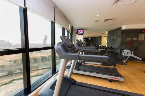 a gym with treadmills and ellipticals in a building at Holiday Inn Abu Dhabi by IHG in Abu Dhabi