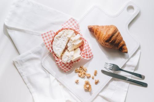 a plate of food with bread and a fork and knife at Holiday Inn Abu Dhabi by IHG in Abu Dhabi