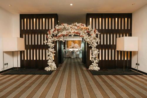 a wedding arch with flowers in a room at Holiday Inn Abu Dhabi by IHG in Abu Dhabi
