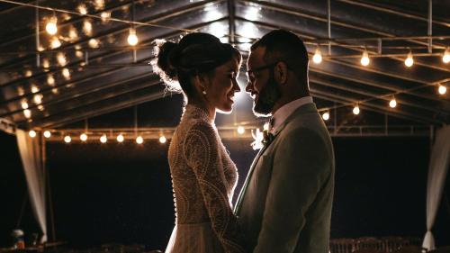 a bride and groom standing next to each other at Holiday Inn Abu Dhabi by IHG in Abu Dhabi
