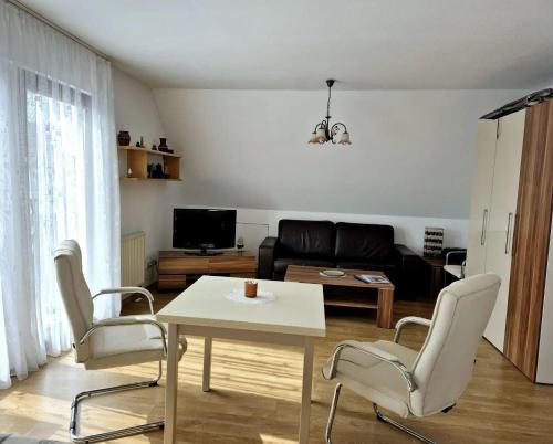 a living room with a table and chairs and a couch at Baltique Fewo 3 in Glowe