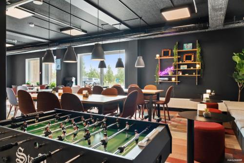 a room with a pool table and chairs at Aiden by Best Western Odense in Odense