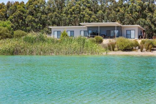 a house on the shore of a body of water at Bonnie and Piper - Lakeside and Wine Country Living in Wilyabrup