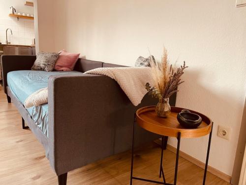 a couch in a living room with a table at Old town apartment with flair centrally located in Weinheim
