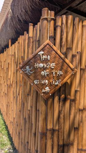 a wooden fence with a sign on top of it at The House of The Rising Tide in Mantaak