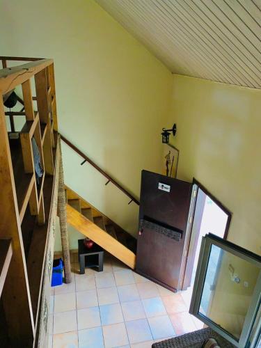 a kitchen with a staircase and a refrigerator in a room at Accra City Studios & Apartment in Accra
