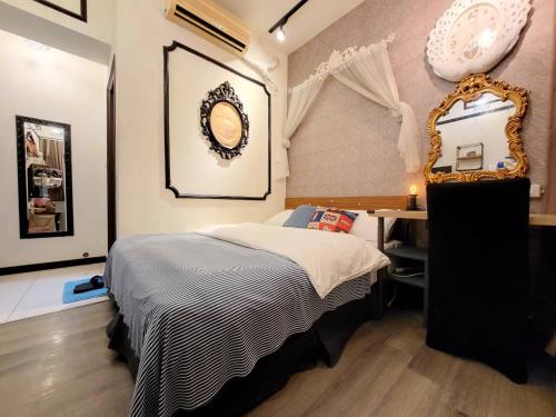 a bedroom with a bed and a mirror and a desk at 一中喵喵 有統編收據 禁菸 非自助 in Taichung