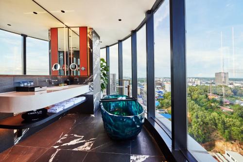 a bathroom with a large bowl on the floor at TRIMULIA Hotel in Sihanoukville