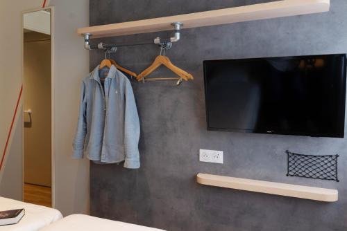 a flat screen tv hanging on a wall at Ibis Budget Saint Malo Centre in Saint Malo