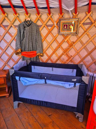 an open suitcase is on display in a yurt at Yourte Mongole traditionnelle in Saint-Pé-de-Bigorre