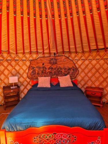 a bedroom with a bed in a yurt at Yourte Mongole traditionnelle in Saint-Pé-de-Bigorre
