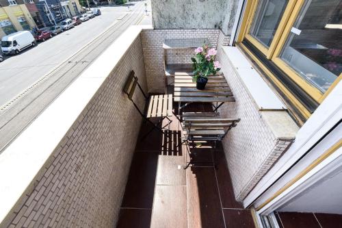 a balcony with two benches and a potted plant at Downtown Buda Homes Relax in Budapest