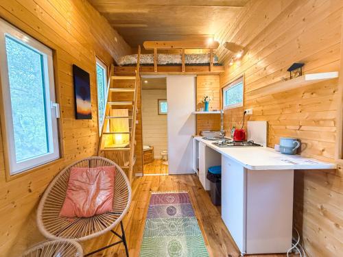a tiny house with a kitchen and a bunk bed at Centre Harmonia in Rennes-les-Bains