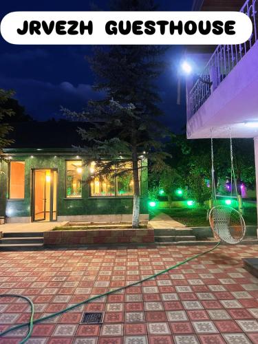 a house with a green hose outside at night at Private house, Own and magnificent villa, Apartments in Yerevan