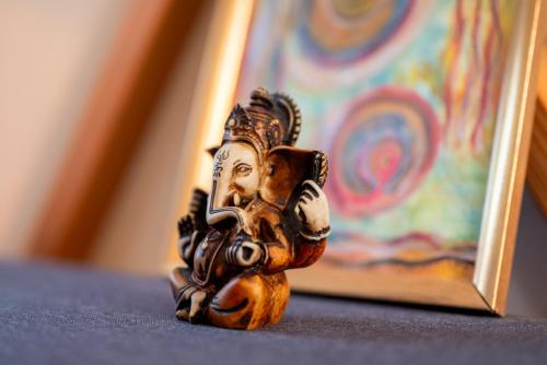 a wooden statuette of a statue next to a painting at Centre Harmonia in Rennes-les-Bains