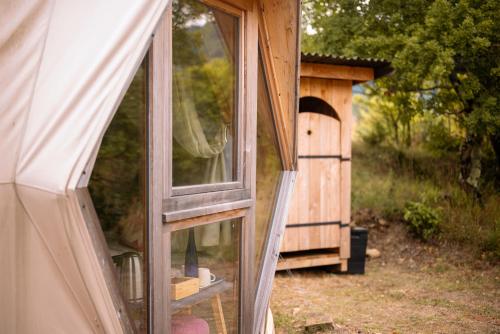 a window of a house with a bird house at Centre Harmonia in Rennes-les-Bains