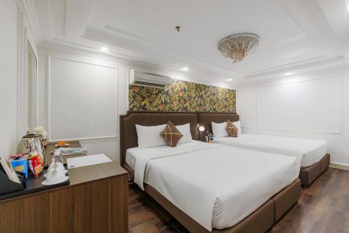 Postel nebo postele na pokoji v ubytování Elite SOFEA Saigon Hotel and Spa