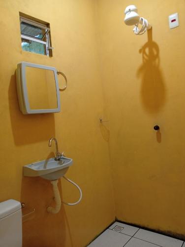 a bathroom with a sink and a mirror on the wall at HOSPEDARIA RECANTO Do MATIAS in Barreirinhas