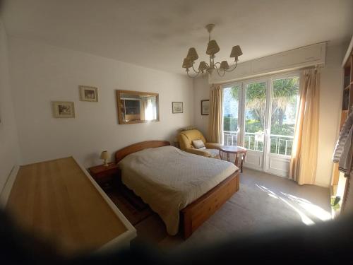 a bedroom with a bed and a large window at Apartement ensoleillé vue mer in Villefranche-sur-Mer