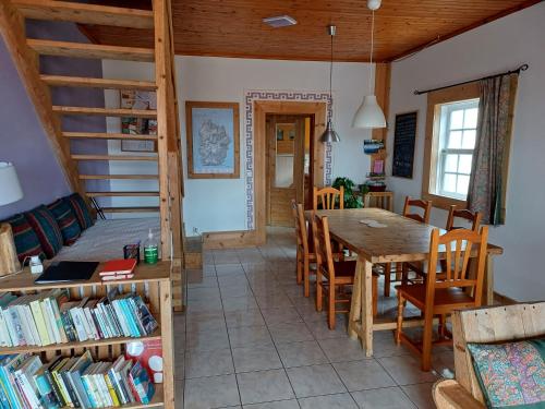 a kitchen and dining room with a table and chairs at A Barraka: rent your room in Flores! in Lajes das Flores