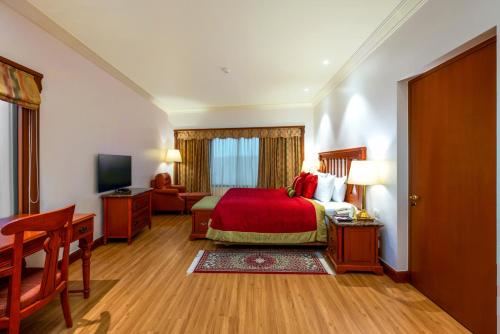 a hotel room with a bed and a television at The Orchid Hotel Mumbai Vile Parle in Mumbai