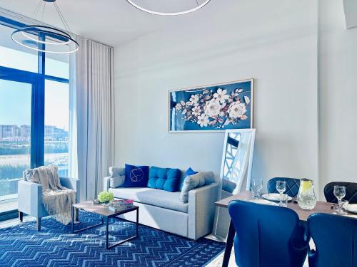a living room with a couch and a table at Modern 2BR Retreat at The Gate in Masdar City in Abu Dhabi