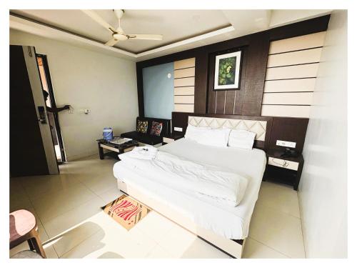 a bedroom with a large white bed in a room at BIG বিগ বস Boss Front The New Digha Sea Beach in Digha