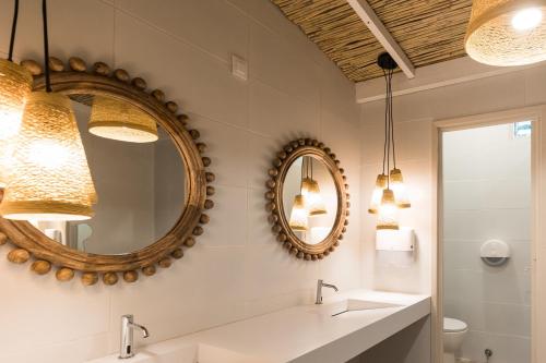 a bathroom with two sinks and a mirror at Beach Club Menorca in Son Parc