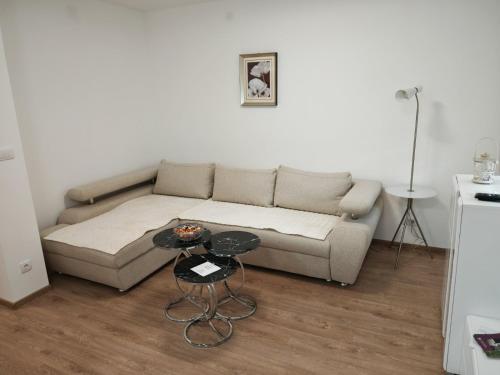 a living room with a couch and a table at Mountain LUX in Rudnik Kačerski