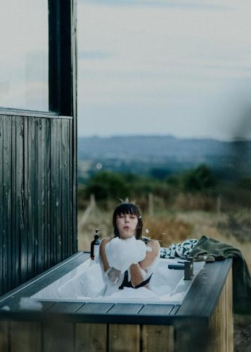 a woman is sitting in a bath tub at Polaris in Kelsall
