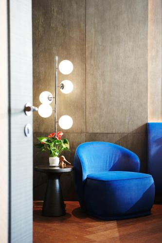 a blue chair in a room with a table at TRIMULIA Hotel in Sihanoukville