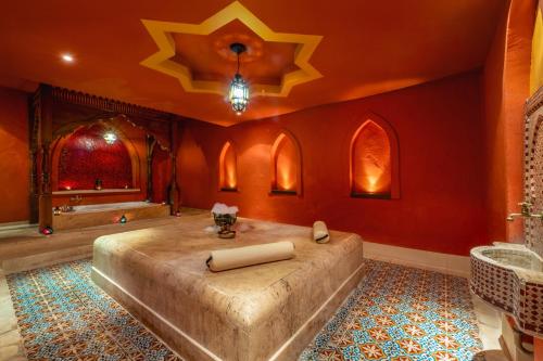 a master bathroom with a large bed and red walls at Mesés Shiraz Hotel Superior-Adults only in Egerszalók