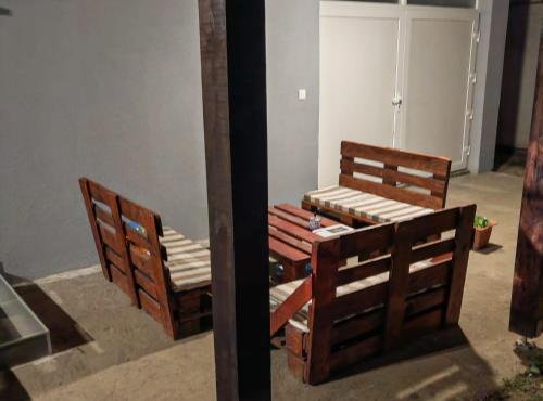 two wooden beds sitting next to each other in a room at Apartmani Tea i Toni in Gradište