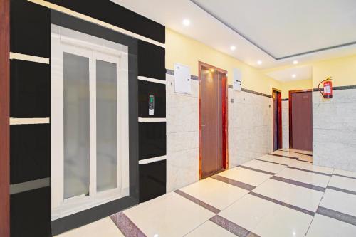 a hallway with black and white walls and a door at Super Collection O Grand Governorpet in Vijayawada