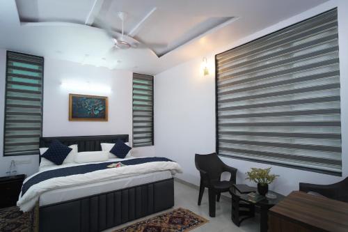 a bedroom with a bed and a table and chairs at Jags-N-Kals in Bhīm Tāl
