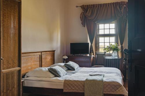 a bedroom with a bed and a window at Zamek Czocha in Leśna