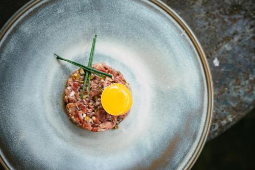 a bowl of food with an egg on top at The Cozy Guestroom near Park Zuid and Musea in Antwerp